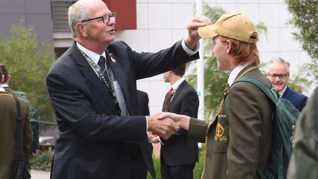 Mr Brown can’t resist an inspection of one student’s locks. Picture: Tony Gough