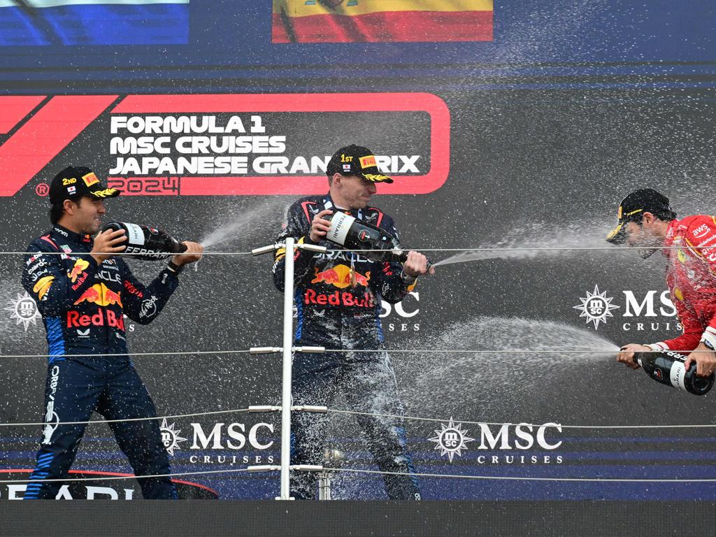 Red Bull Racing's Max Verstappen (C) celebrates his Japan GP victory with second-placed Sergio Perez (L) and third-placed Carlos Sainz Jr (R). Picture: AFP