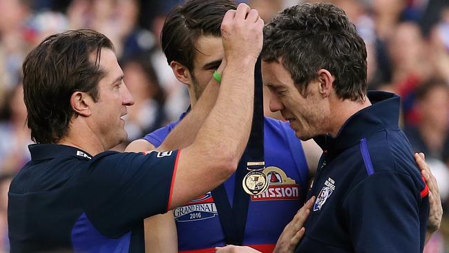 Luke Beveridge gives his premiership medal to a very emotional Bob Murphy. Picture: Wayne Ludbey