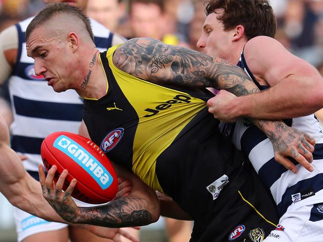 AFL Round 21. Geelong v Richmond at Simonds Stadium.  Richmond's Dustin Martin tries to break through the tackle of Jed Bews  . Pic: Michael Klein