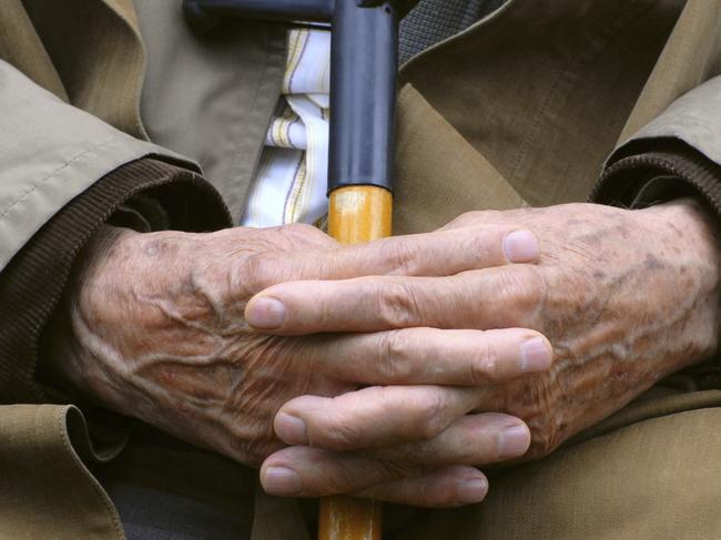 Man resting with walking stick