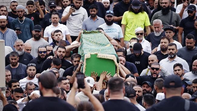 Mourners carry Taha Sabbagh’s green coffin out of Lakemba Mosque today. Picture: Sam Ruttyn