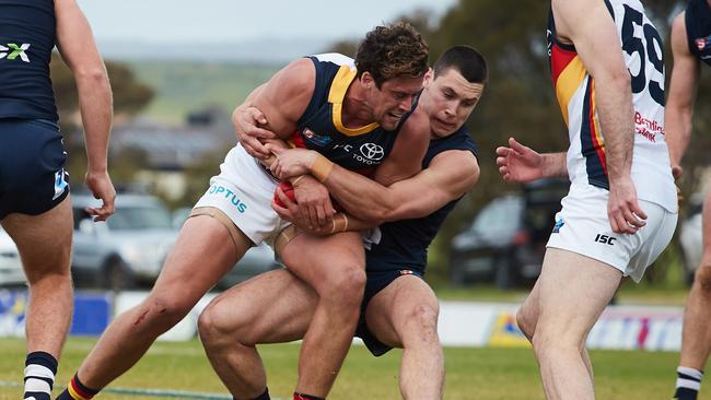 Kyle Hartigan is tackled by Liam Fitt at Noarlunga Oval in the SANFL match between Adelaide and South Adelaide in August last year. Picture: MATT LOXTON