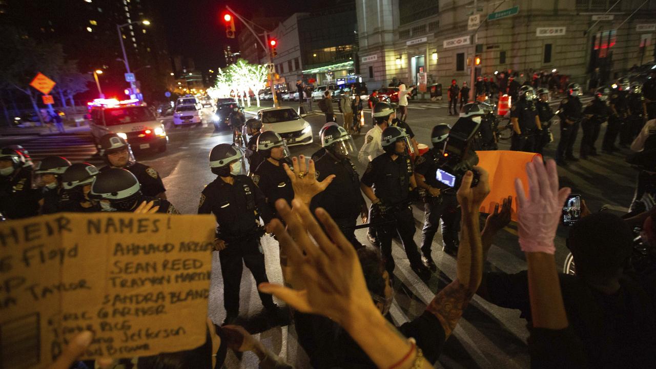 Police face off with activists during a protest march near the Manhattan Bridge in New York. Picture: AP/Kevin Hagen