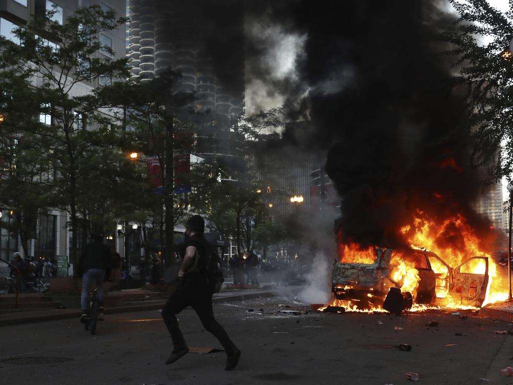 A car burns in Chicago after a march and rally over the death of George Floyd. Picture: John J. Kim