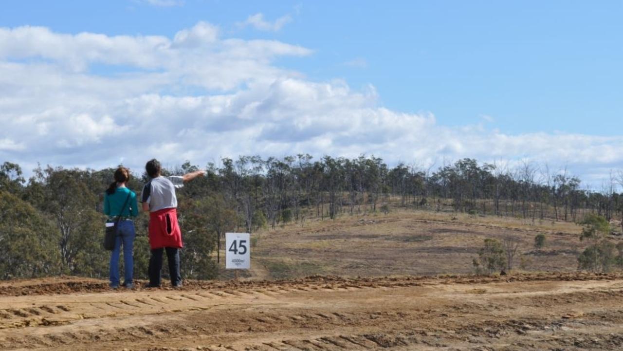 Residents inspect the blocks being offered in the land swap arrangement for people who lost their homes in the Grantham floods. supplied. August 2011.