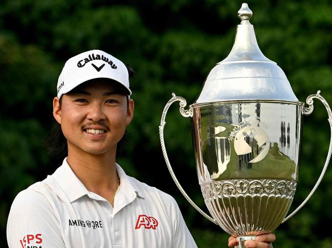 This handout photo taken and released by the Asian Tour on October 15, 2023 shows Min Woo Lee of Australia celebrating with the winner's trophy of the Macau Open at the Macau Golf and Country Club. (Photo by Paul LAKATOS / Asian Tour / AFP) / RESTRICTED TO EDITORIAL USE - MANDATORY CREDIT "AFP PHOTO / Asian Tour / Paul Lakatos" - NO MARKETING NO ADVERTISING CAMPAIGNS - DISTRIBUTED AS A SERVICE TO CLIENTS - NO ARCHIVES