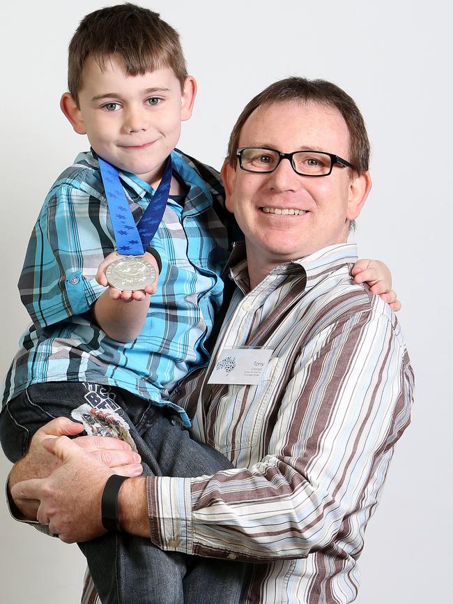 Tony George with his son Bailey — picking up the Child of Courage Medal for Chelsea George. Picture: Simon Cross