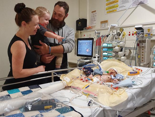 Hayden on life support with his parents Laura and Graham and big brother Hunter by his side. Picture: Supplied