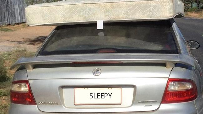 A driver was caught holding onto a mattress with his hand while driving in Alice Springs on Friday. Police have cheekily covered up the number plate and replaced it with the word 'sleepy'. Picture: NT Police