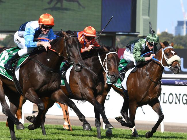 MELBOURNE, AUSTRALIA - MARCH 12: Josh Parr riding Duais defeat Think it Over and Spanish Mission in Race 7, the Tab Australian Cup, during Melbourne Racing at Flemington Racecourse on March 12, 2022 in Melbourne, Australia. (Photo by Vince Caligiuri/Getty Images)