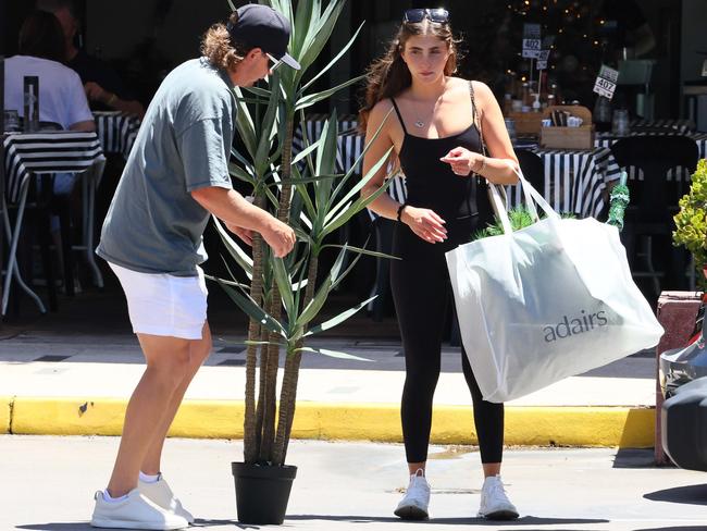 Smith and Naoum try to negotiate pot plant into the back of the car. Picture: News Corp exclusive pics.