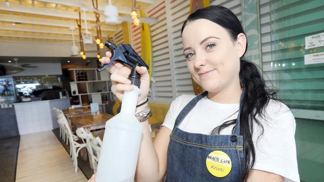 Ibis and pigeons are harassing patrons at a strip of shops at Surfers Paradise. Waitress Kristi McGrail from the Surfers Paradise Beach Cafe chasing one away. Picture: Mike Batterham