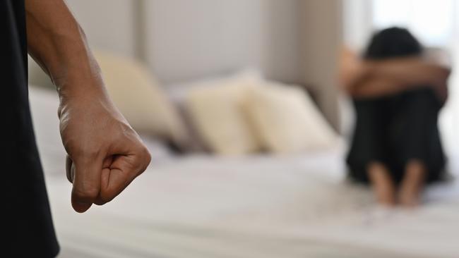 istock generic:  woman, abuse, DV, domestic violence, harassment, sexual harassment.   Selective focus on the fist male with crying man sits on a bed as the background, Violence, Love and relationships, Gay couple, sexual harassment concept. . Picture: istock