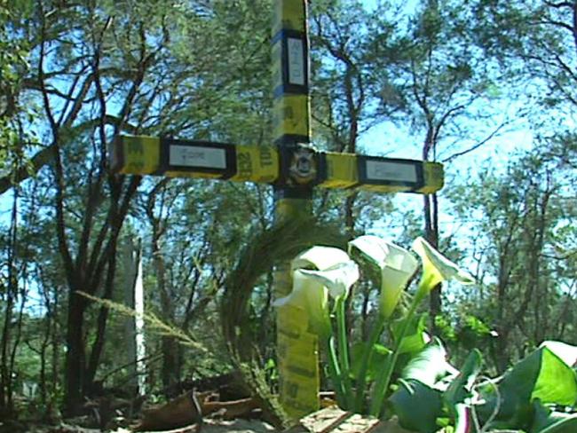 Winter arum lilies grow at the base of the makeshift cross erected by police where Jane Rimmer’s body was found. Picture: Michelle Stanley/Post Newspapers