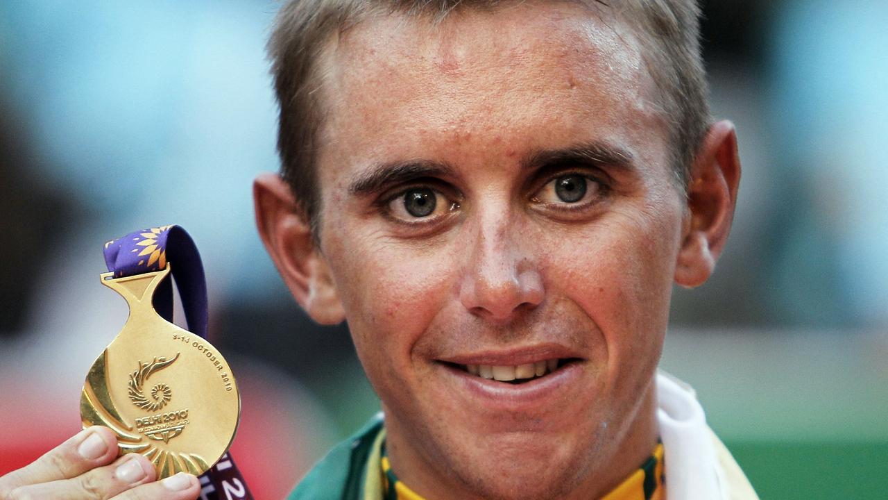 Australia's Allan Davis poses with his gold medal after winning the men's 168km cycling road race during the Commonwealth Games in New Delhi, India, Sunday, Oct. 10, 2010. (AP Photo/Victor R. Caivano)