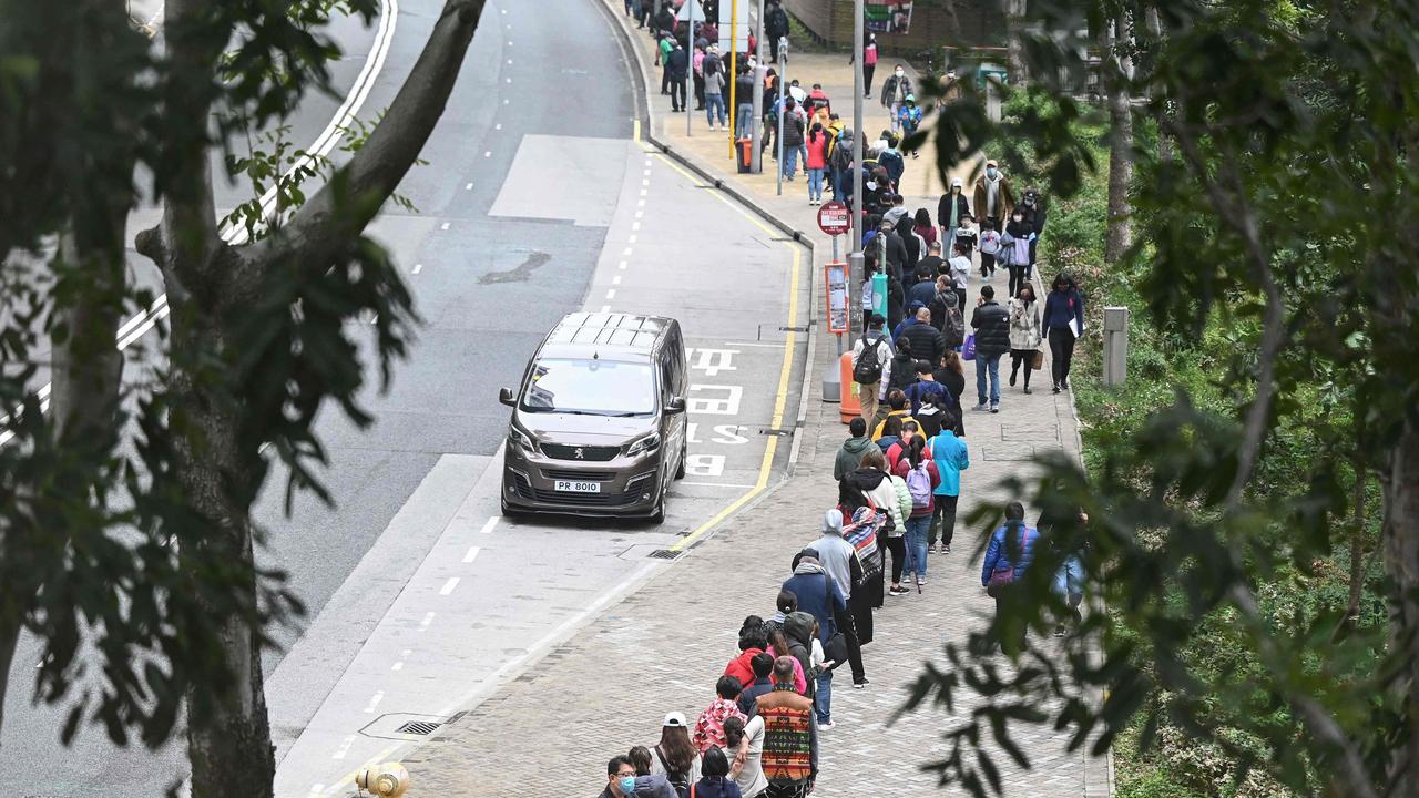 People queue at a mobile specimen collection station for Covid-19 testing in Hong Kong’s Tung Chung district. (Photo by Peter PARKS / AFP)