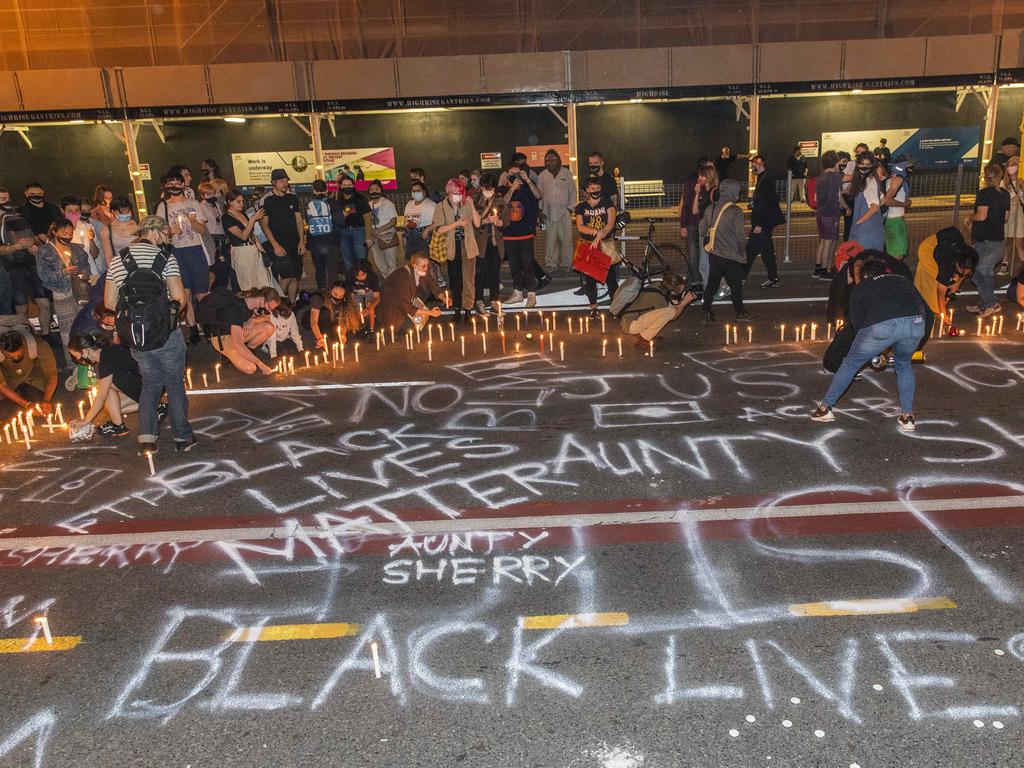 Protesters spray-paint the road outside the watch-house last Friday. Picture: Richard Walker