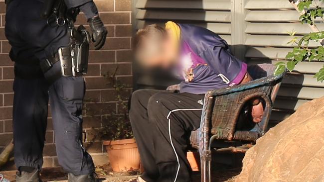 Police arrest a man in the rear of the home. Picture: NSW Police