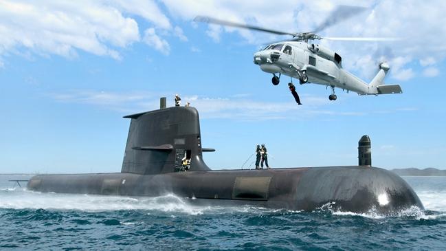 HMAS Sheean conducting an Air Sea Safety Assesment off Garden Island in Western Australia with HMAS Adelaide's SeaHawk helicopter. The ageing submarine is expected to be out of the water until at least the end of the year.