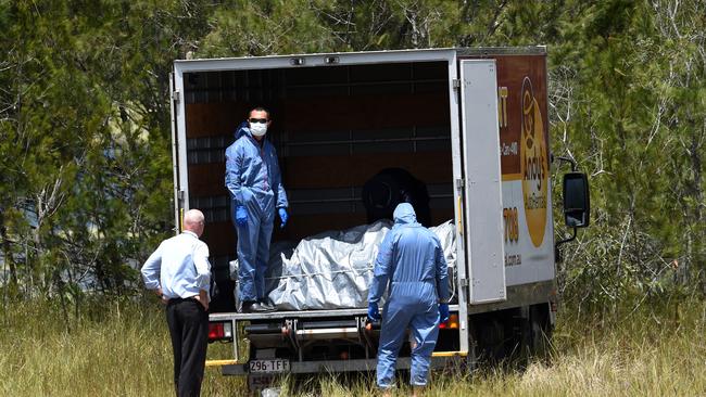 Police load a metal box onto a van after pulling it from a dam in Logan. Picture: AAP Image/Dan Peled