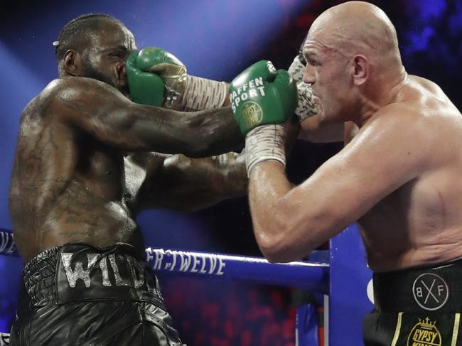 FILE - In this Feb. 22, 2020, file photo, Tyson Fury, of England, lands a right to Deontay Wilder, left, during a WBC heavyweight championship boxing match in Las Vegas. Boxing promoter Bob Arum says he plans to stage a card of five fights on June 9 at the MGM Grand. It's the first of a series of fights over the next two months at the Las Vegas hotel. A second fight card will be held two nights later. ESPN will televise both cards to kick off twice weekly shows at the hotel in June and July. The fights are pending approval of the Nevada Athletic Commission. (AP Photo/Isaac Brekken, File)