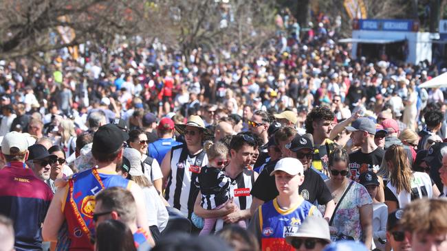 Crowds at the AFL Grand Final Parade at Yarra Park in Melbourne on Friday. Picture Lachie Millard