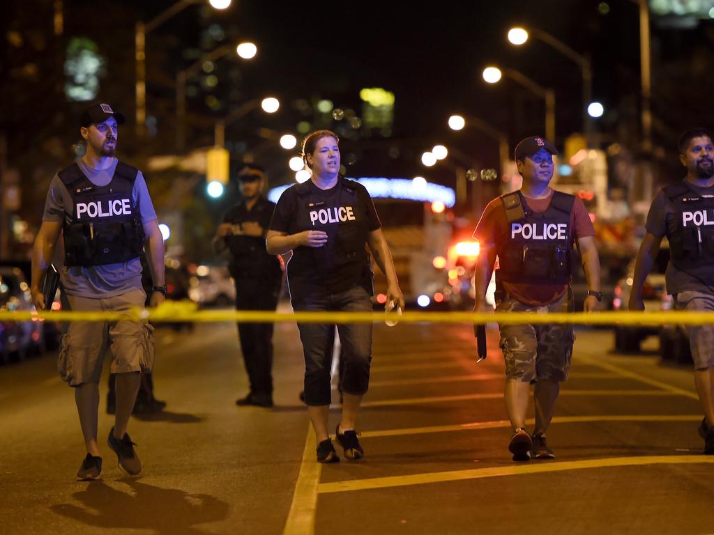 Plain clothes police officers work the scene of shooting in Toronto. Picture: AP