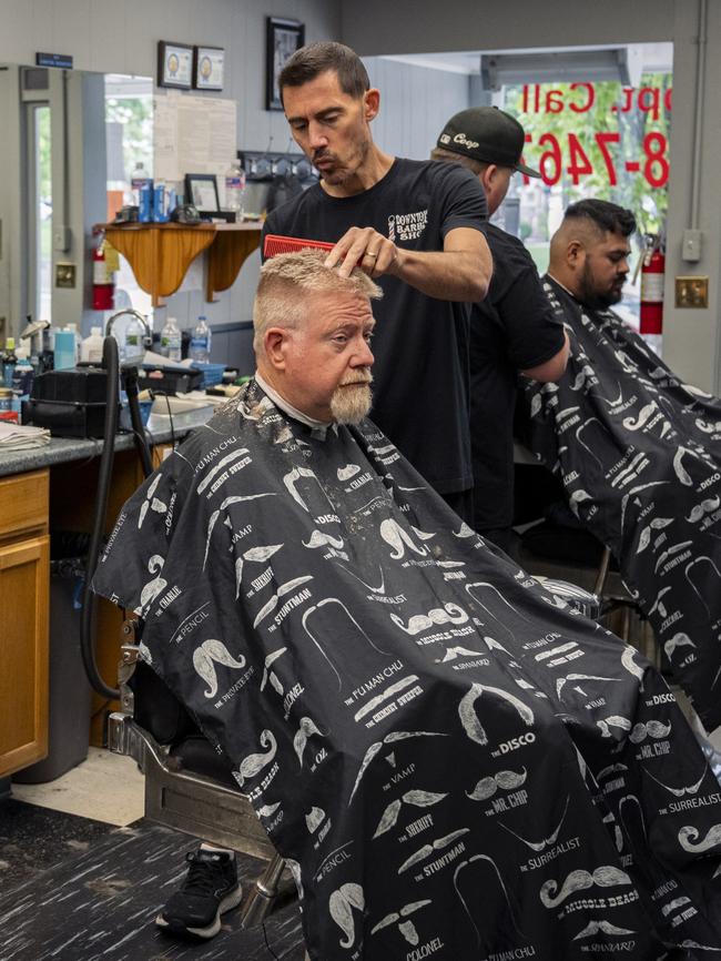 Barbershop owner Andy Steenrod says he will put his money on Kamala Harris to win the election. Picture: Eli Hiller