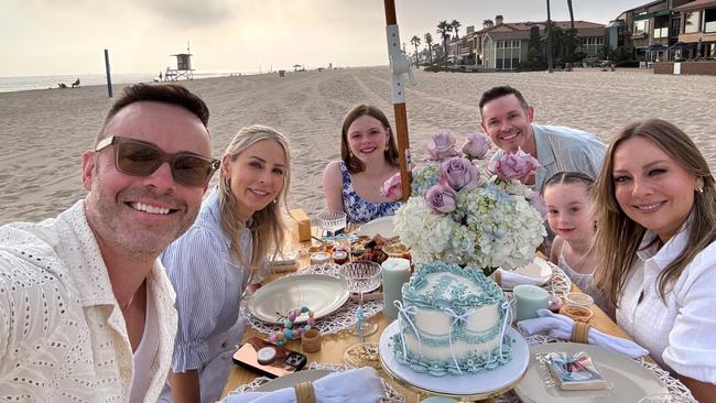 Michael and Andrew Tierney on a beach holiday with their families.