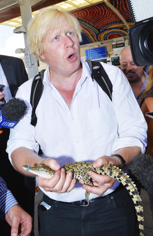 Former UK Prime Minister and then London Mayor Boris Johnson holds George the royal baby crocodile at Darwin Airport on a visit in 2013. Picture: Elise Derwin