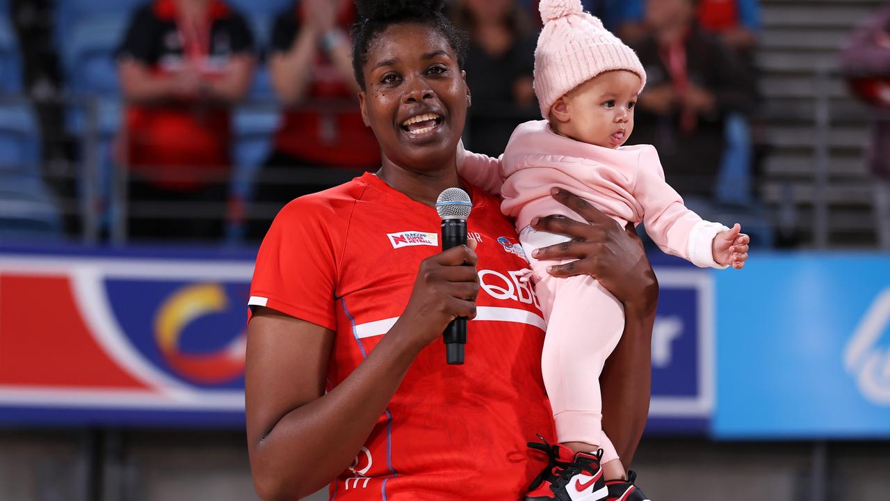 Romelda Aiken-George and daughter Gianna, celebrate her 200th national league match in the red dress of the Swifts. Photo: Getty Images