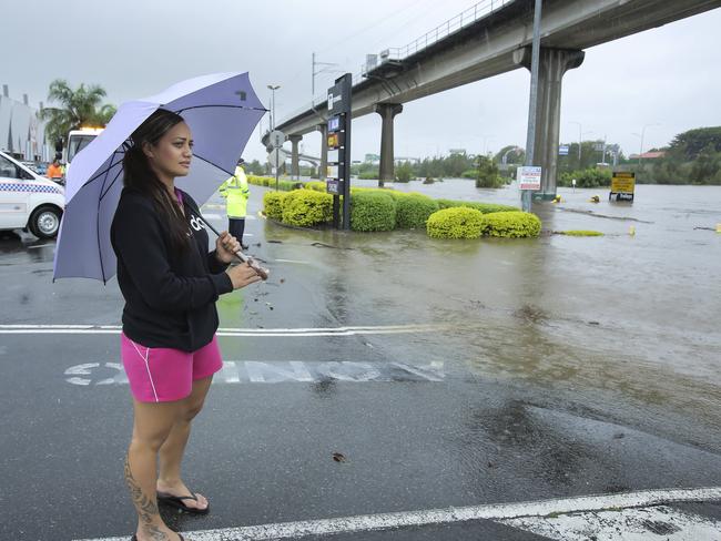 Lara Rangitaawa looking at the flooded car park of Toombul Shopping Centre in Brisbane’s north. Picture: Mark Cranitch