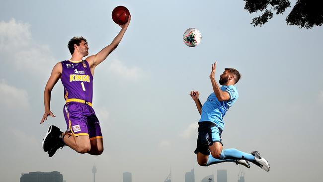 Sydney Kings’ Jordan Hunter and Sydney FC’s Michael Zullo take to the air at Rushcutters Bay, Sydney to mark a new sports partnership. Picture: Phil Hillyard