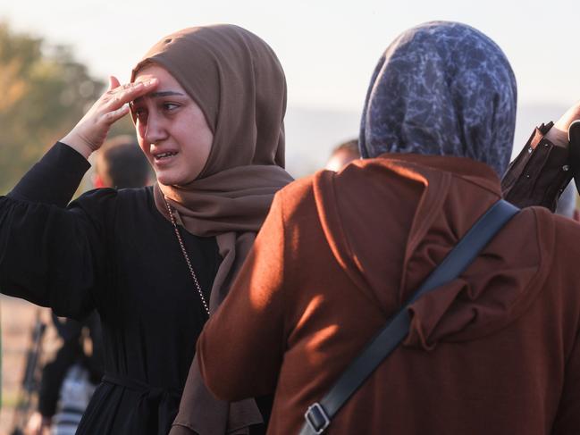 Distraught relatives of employees gather outside the building. Picture: Getty Images