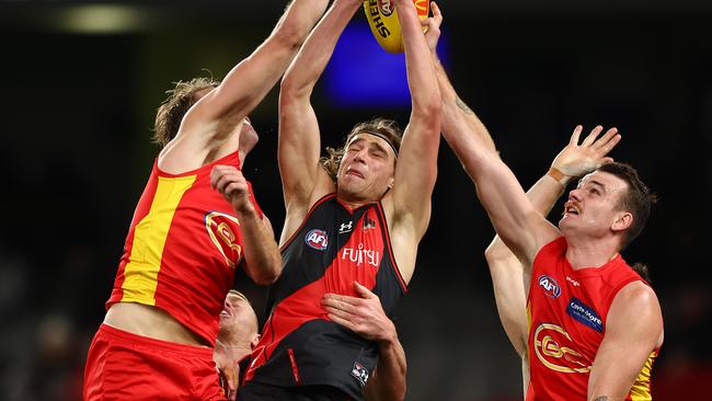 MELBOURNE, AUSTRALIA - JULY 17: Harrison Jones of the Bombers (C) takes a mark during the round 18 AFL match between the Essendon Bombers and the Gold Coast Suns at Marvel Stadium on July 17, 2022 in Melbourne, Australia. (Photo by Graham Denholm/AFL Photos via Getty Images)