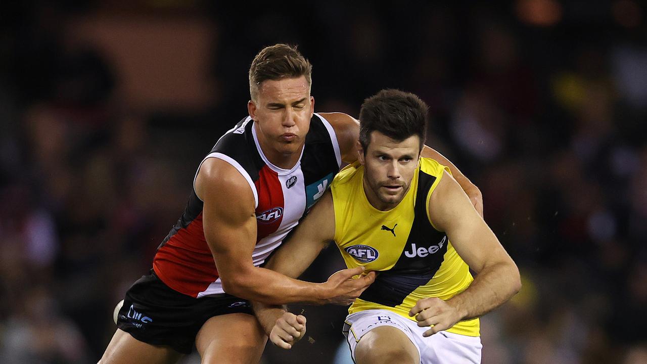 AFL Round 5. 15/04/2021. St Kilda vs Richmond at Marvel Stadium, Melbourne. Richmonds Trent Cotchin clears infant of Jack Bytel of the Saints during the 3rd qtr. . Pic: Michael Klein