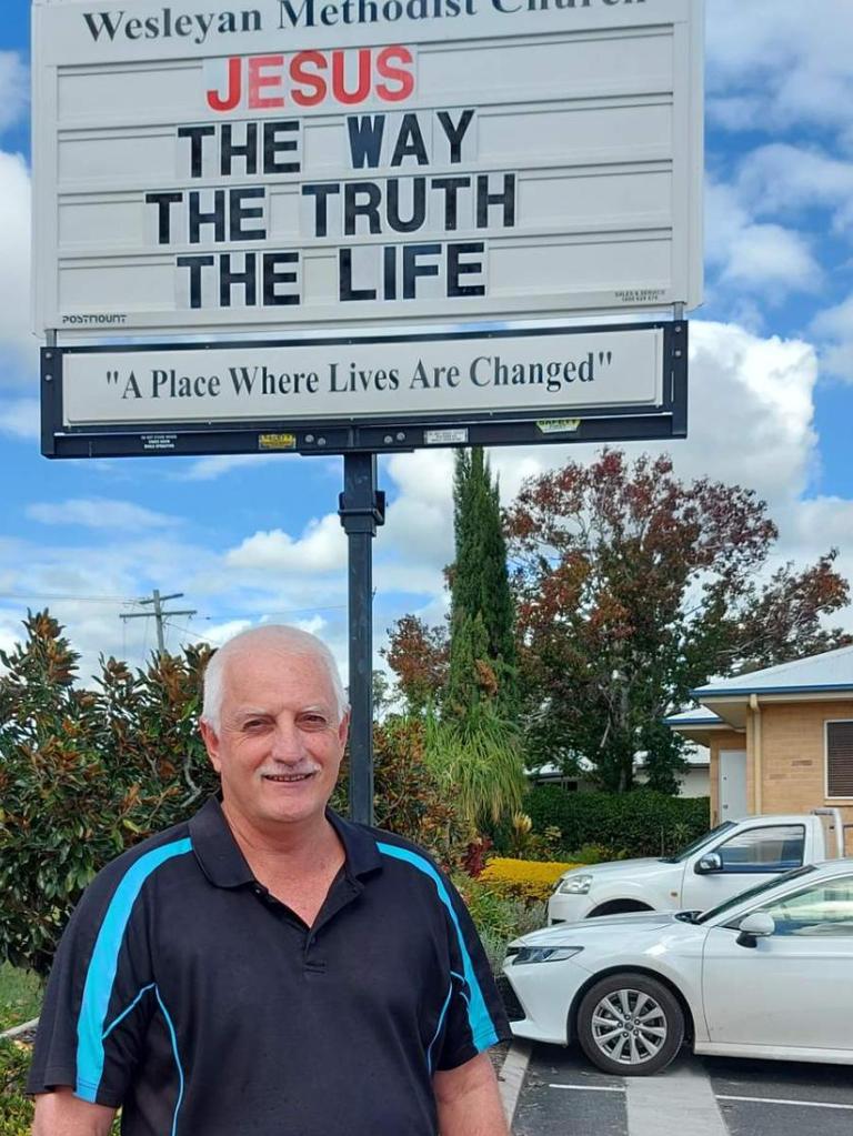 Reverend Gary McClintock and the message board at the Wesleyan Methodist Church on Tuesday.