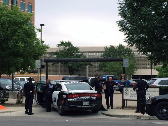 Police stand guard in front of Dallas Police headquarters in an apparent lockdown as part of heightened security measures. Picture: AP