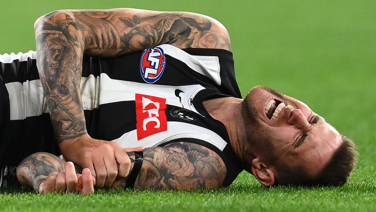 MELBOURNE, AUSTRALIA - MARCH 17: Jeremy Howe of the Magpies lays on the ground in pain during the round one AFL match between Geelong Cats and Collingwood Magpies at Melbourne Cricket Ground, on March 17, 2023, in Melbourne, Australia. (Photo by Quinn Rooney/Getty Images)