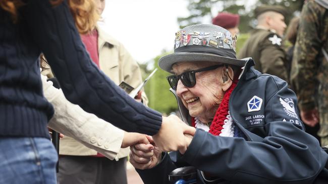 World War II veteran Jake Larson meets youths during ceremonies at the US cemetery in Colleville-sur-Mer, Normandy. Picture: AP /Thomas Padilla