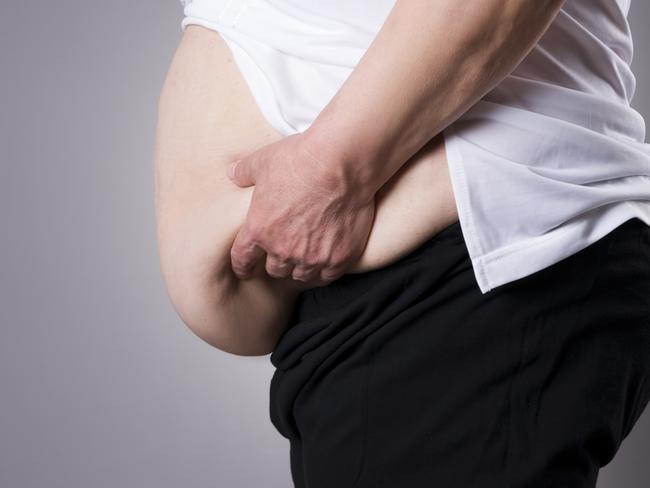 Fat human body. Fatty belly closeup on gray background  Picture: istock