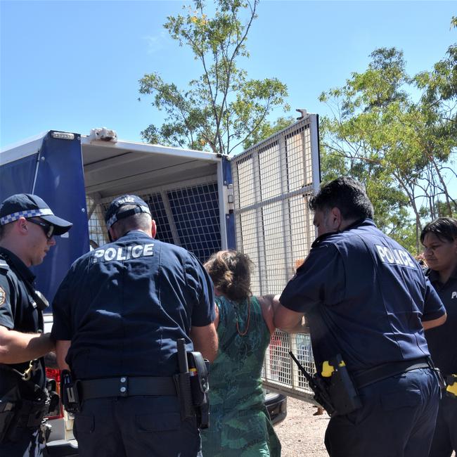 A woman is loaded into the back of a police vehicle. Picture: Sierra Haigh