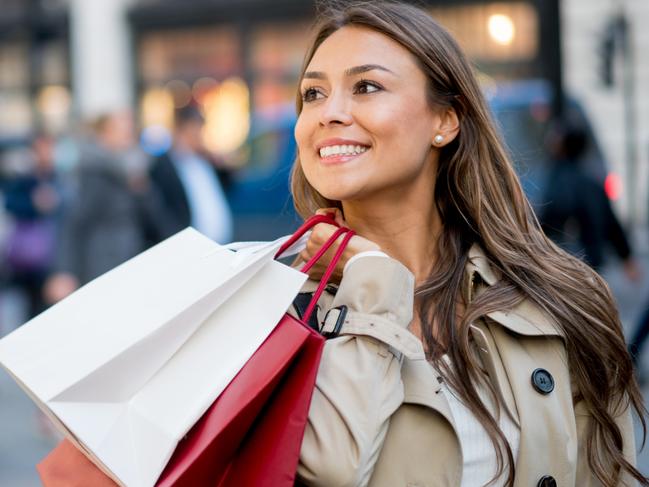 A woman carrying her shopping bags after spending money on her credit card. Picture: iStock.