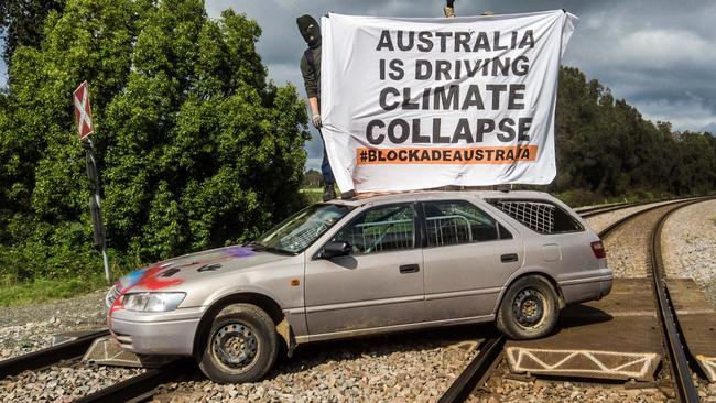 A car, fitted with metal bar, is parked across the rail line for more than two hours. Picture: Blockade Australia/Facebook