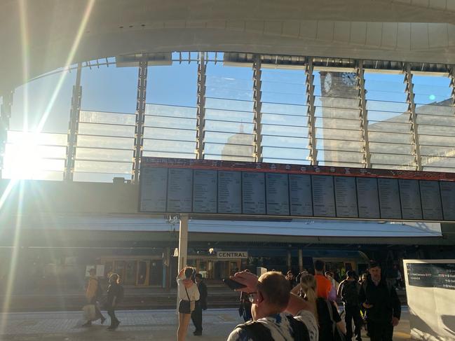 Commuters shield their eyes from the glare of the afternoon sun at Central.