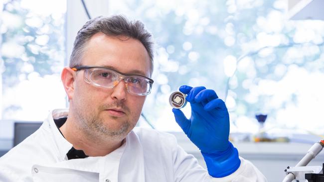 Dr David Muller of UQ with the vaccine patch that could deliver a Covid-19 vaccine.