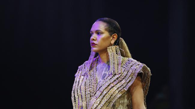 Sarah Eggmolesse wears a Delvene Cockatoo-Collins design at the Cairns Indigenous Art Fair fashion performance, Woven, held at the Tanks Arts Centre, Edge Hill. Picture: Brendan Radke