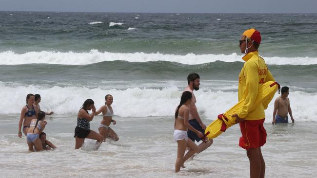 Surfers Paradise lifesaver Nathan Gray watches swimmers in the rough conditions — Surf Life Saving Queensland have launched a new campaign to highlight awareness of rips. Picture: Glenn Hampson