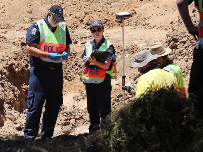 The excavation at the Castalloy factory for the Beaumont Children on Friday. Pictured is a forensic crime scene investigator looking at items found in the soil. Picture: Dylan Coker